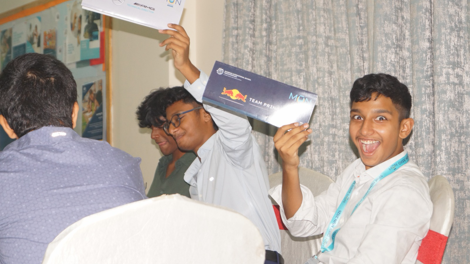 Students celebrating with team placards during committee proceedings