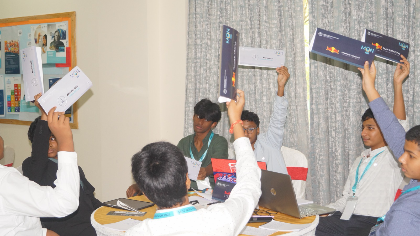 Delegates raising branded placards during an active voting moment