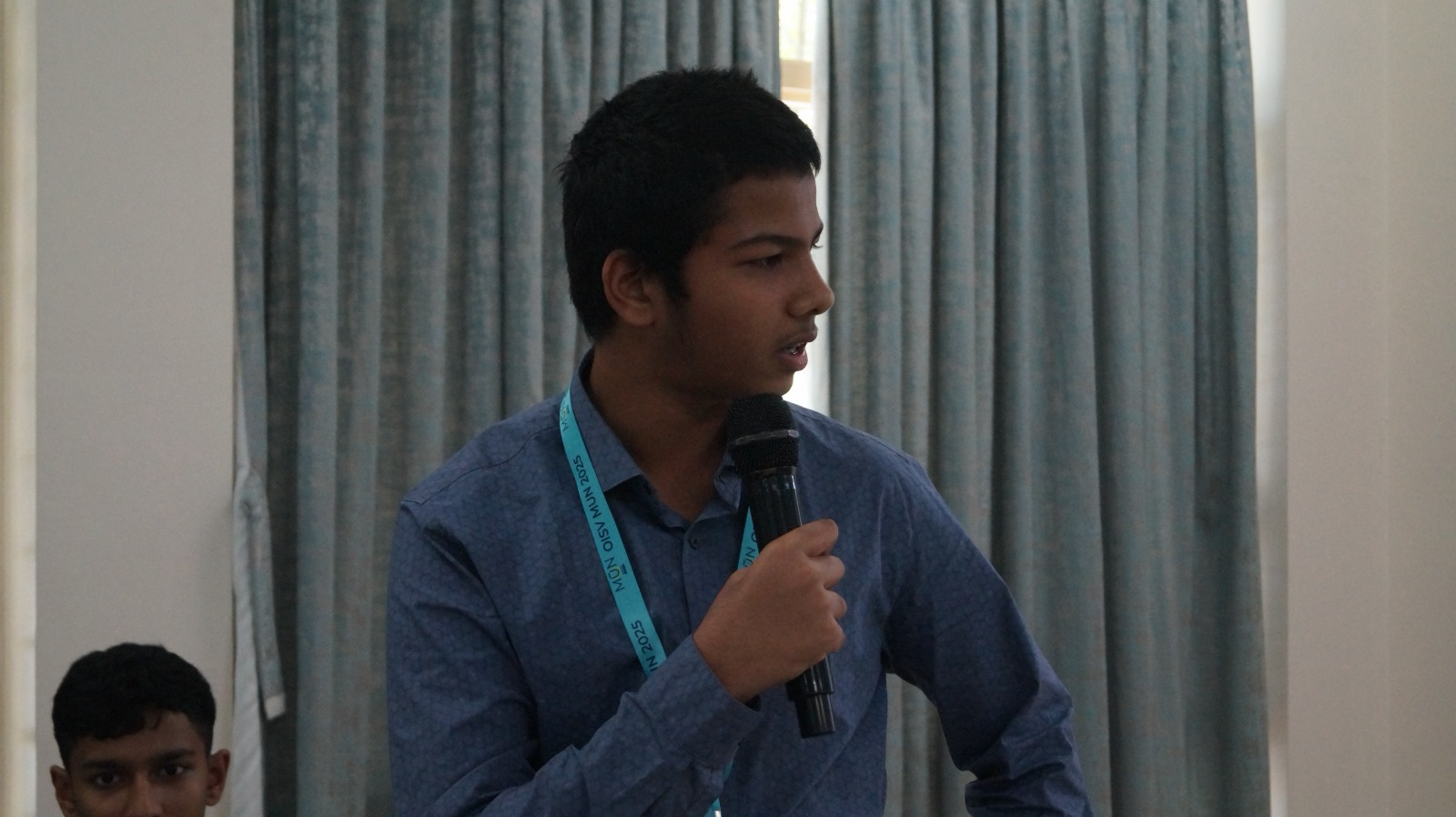 Committee delegate speaking into a microphone during moderated debate